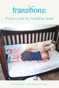 Text: Transition: from crib to toddler bed  Picture: toddler boy smiling and pretending to sleep on his toddler bed