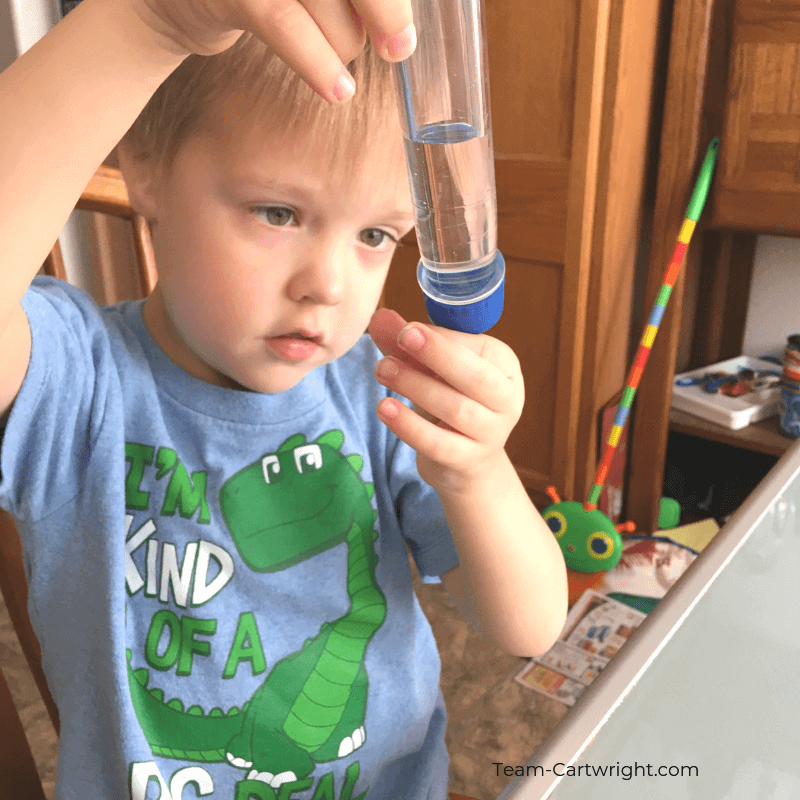 picture of a preschooler looking at a test tube
