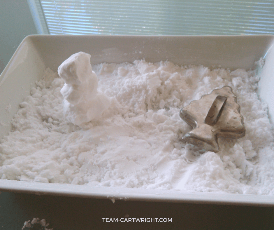 Make fake snow that is actually cold with just 2 ingredients! Easy and fun Christmas science experiments for kids. #christmasscience #christmasSTEM #christmas #STEM #science #learningactivity #kids #toddlers #preschool Team-Cartwright.com