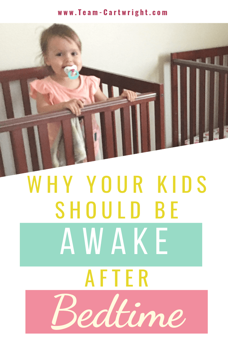 picture of a toddler standing up in a crib with text overlay Why Your Kids Should Be Awake After Bedtime