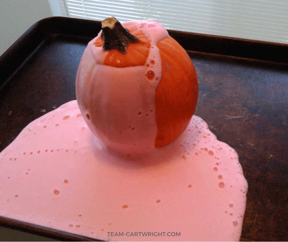 Small pumpkin with red foam coming out of the top.