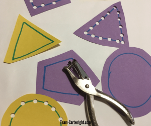 Practice cutting skill safely by using a hole punch! Work a lot of the same skills with less worry. #HolePunch #ScissorSkills #CuttingPractice #SafeScissors Team-Cartwright.com