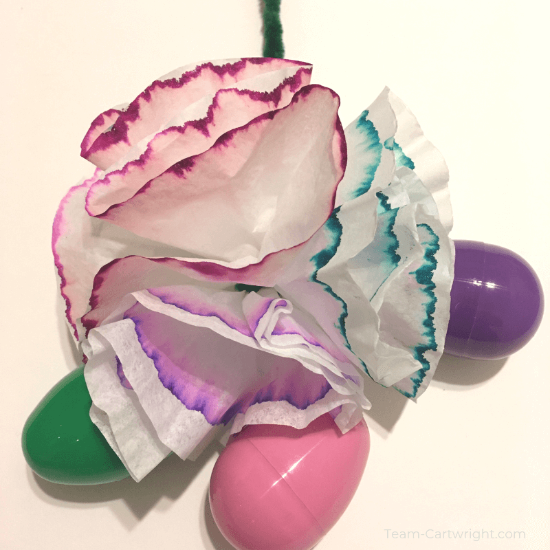 picture of colorful flower craft and plastic easter eggs