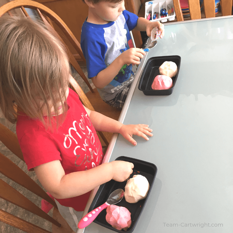 picture of toddler girl and preschool boy playing with ice cream playdough at a table