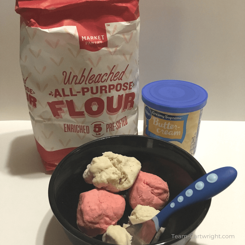 picture of flour bag, can of frosting, and black bowl of pink and white ice cream playdough with blue spoon