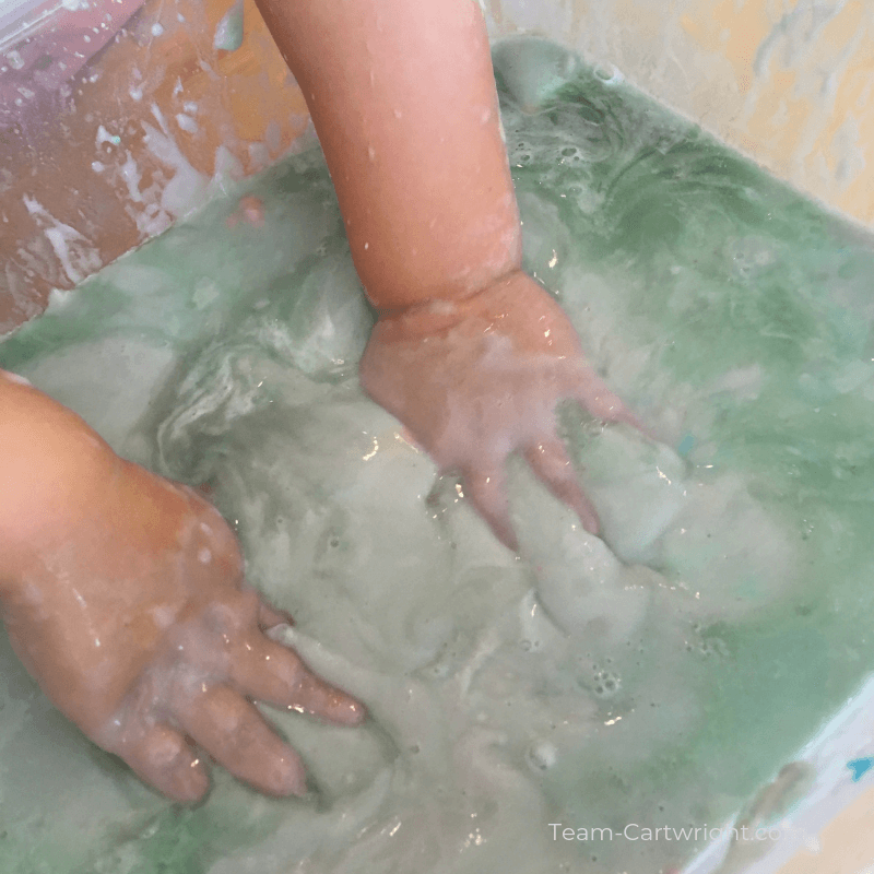 picture of a child's hands in a messy sensory bin