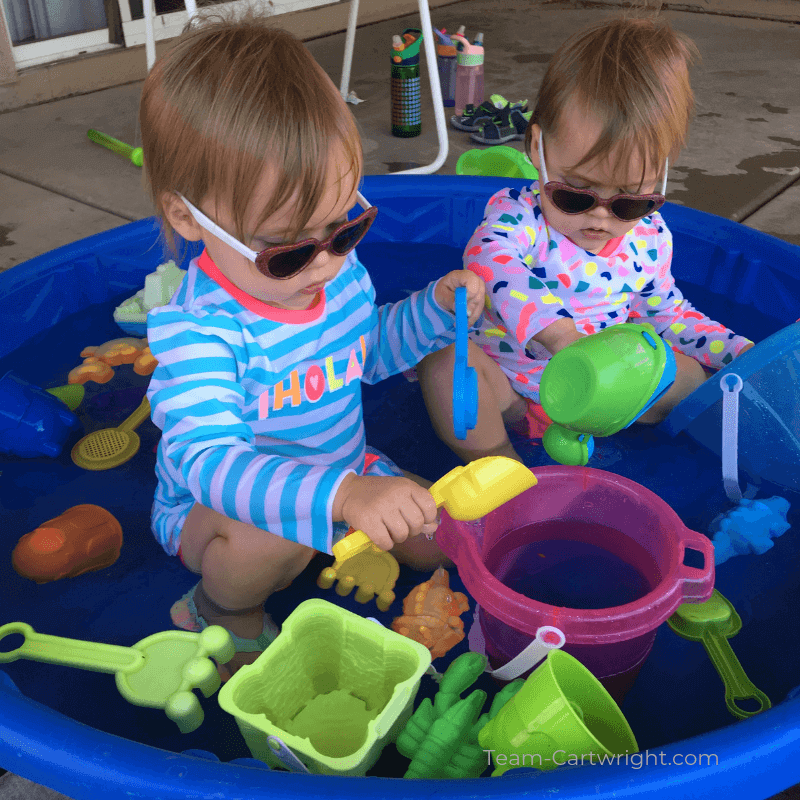 picture of two toddlers playing in a kiddie pool