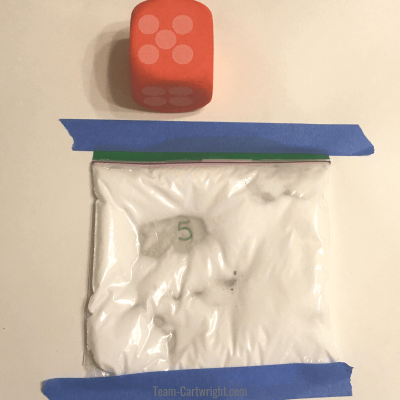 picture of a red dice with the number 5 showing and sensory bag of shaving cream with the number 5 revealed