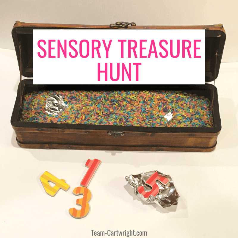 Sensory treasure hunt with picture of treasure chest full of rainbow rice and foil covered numbers and unwrapped numbers in front.