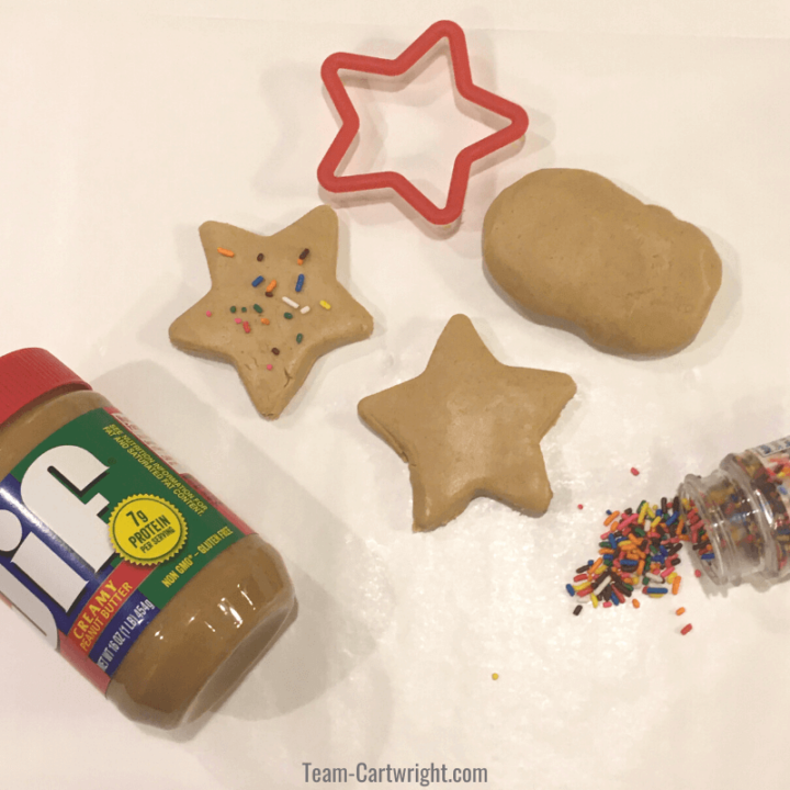 picture of peanut butter playdough, star cookie cutter, sprinkles, and jar of peanut butter