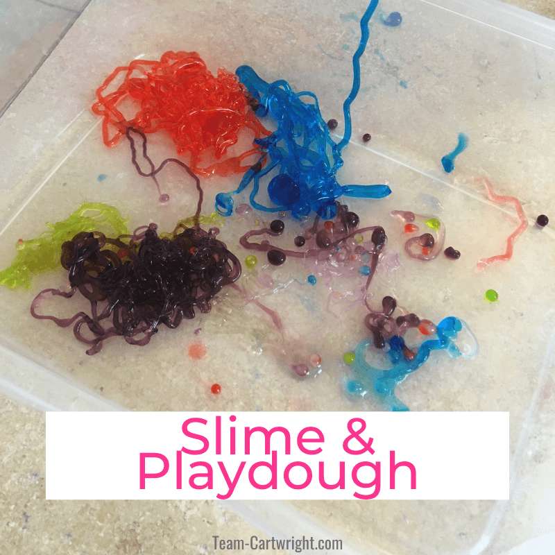 Link to: DIY slime and playdough recipes Text: Slime & Playdough Picture: Bin with slime worms in purple, red, blue, and green