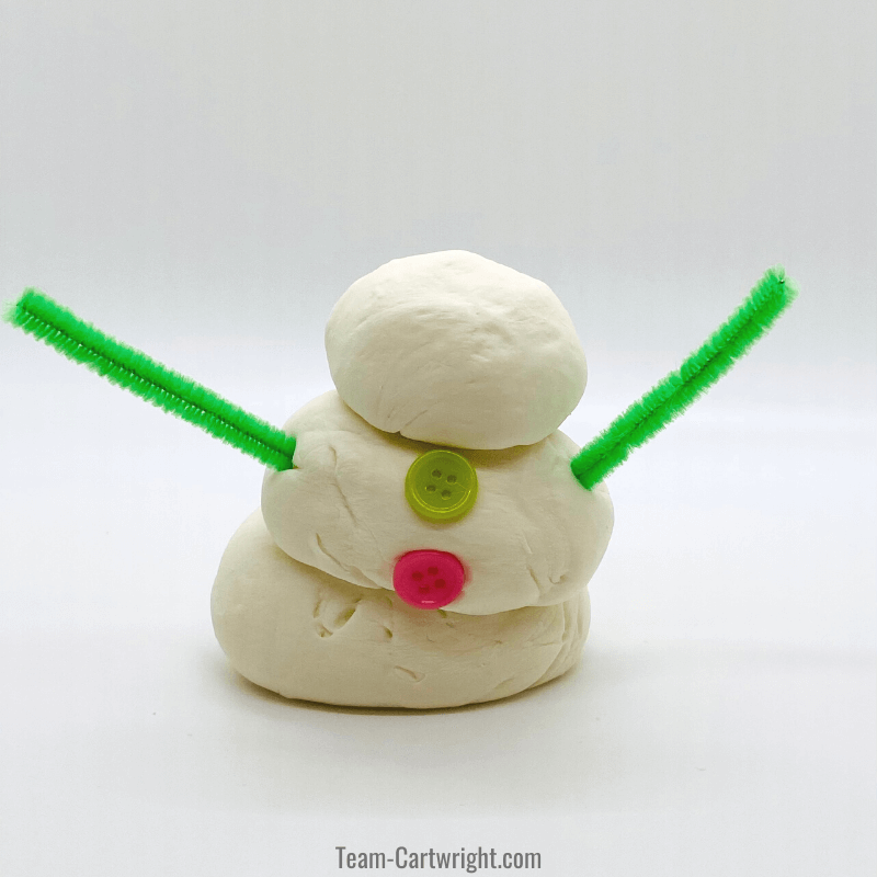 snowman with buttons and pipe cleaner arms made from marshmallow playdough