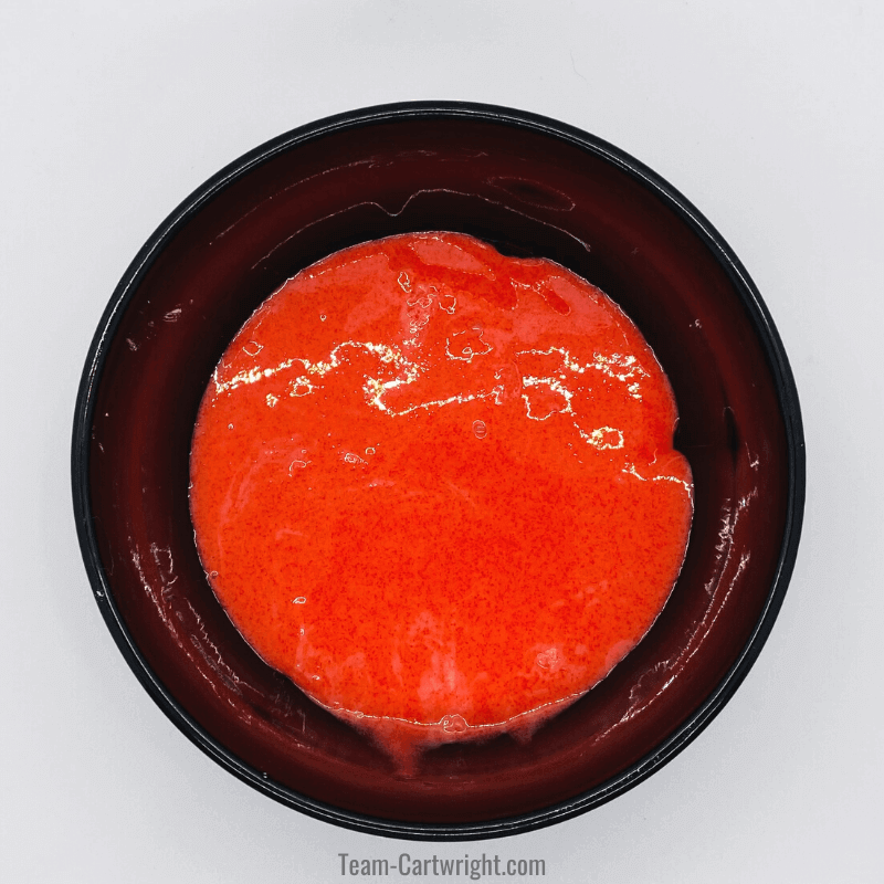 black bowl with red slime in it made from  jello and cornstarch